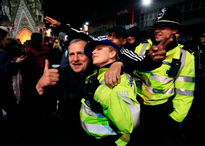 Police join in with the Leicester City fans in Leicester as they celebrate seeing their side crowned Barclays Premier League champions following Tottenham Hotspur's 2-2 draw against Chelsea. Photo : Jonathan Brady / PA Images / Icon Sport